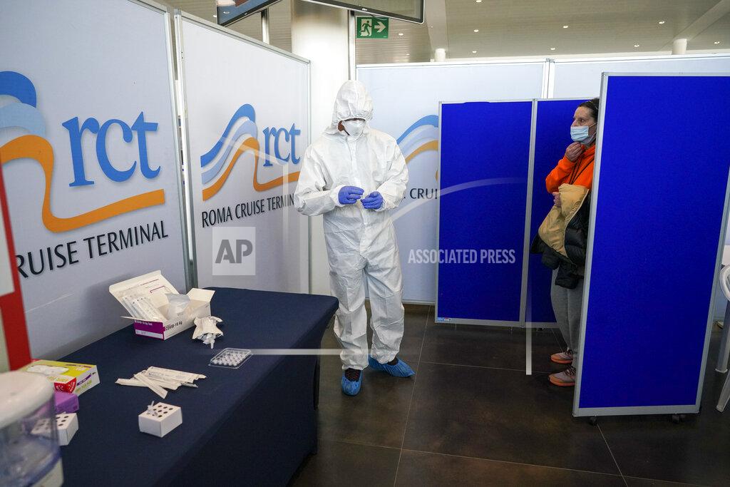 Andrew Medichini Passenger Loredana Battistoni, right, waits to receive a Covid-19 test prior to boarding the MSC Grandiosa cruise ship in Civitavecchia, near Rome, Wednesday, March 31, 2021. MSC Grandiosa, the world's only cruise ship to be operating at the moment, left from Genoa on March 30 and stopped in Civitavecchia near Rome to pick up more passengers and then sail toward Naples, Cagliari, and Malta to be back in Genoa on April 6. For most of the winter, the MSC Grandiosa has been a lonely flag-bearer of the global cruise industry stalled by the pandemic, plying the Mediterranean Sea with seven-night cruises along Italy’s western coast, its major islands and a stop in Malta. (AP Photo/Andrew Medichini)