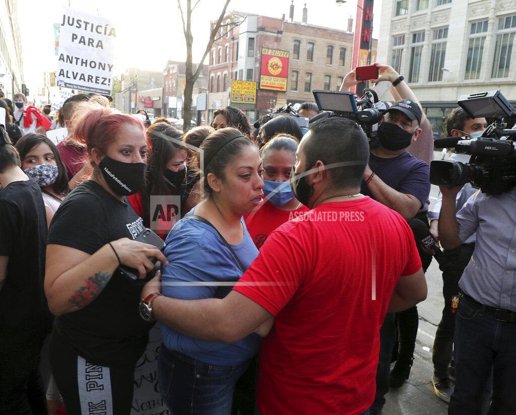 Terrence Antonio James Veronica Alvarez, center, the mother of 22-year-old Anthony Alvarez, is comforted by supporters on Tuesday, April 27, 2021, outside the headquarters of the Civilian Office of Police Accountability in Chicago. Chicago’s independent police review board has released video of the 22-year-old Latino man who was shot in the back late last month during a foot chase. (Jose M. Osorio /Chicago Tribune via AP)