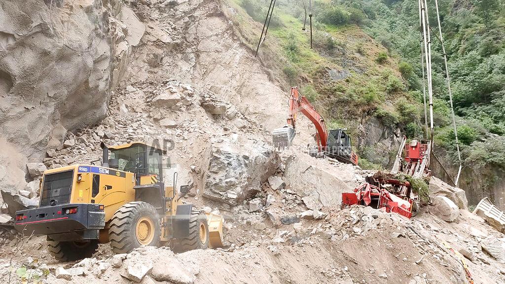 Uncredited In this handout photograph provided by the Jammu and Kashmir Government's Department of Disaster Management, earthmovers work to clear the site where an under construction tunnel collapsed in Ramban district, in Indian-controlled Kashmir, Friday, May 20, 2022. An official said Friday that 10 workers were trapped after part of an under construction road tunnel collapsed in the Himalayan region. (Jammu and Kashmir Government's Department of Disaster Management via AP)