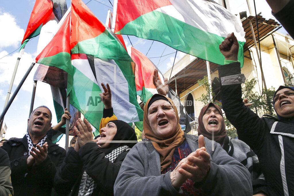 Bilal Hussein FILE - This Friday, Jan. 31, 2020 file photo, Palestinians chant slogans as they hold Palestinian flags, during a protest against the White House plan for ending the Israeli-Palestinian conflict, at Burj al-Barajneh refugee camp, south of Beirut, Lebanon. The financial crisis that the U.N. agency for Palestinian refugees is experiencing could lead to ceasing some of its activities in what would raise risks of instability in this volatile region, the head of the agency said Wednesday, Sept. 16. (AP Photo/Bilal Hussein, File)