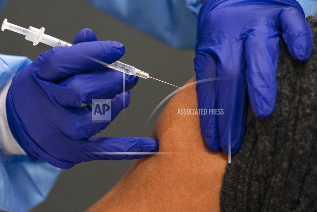 Jacquelyn Martin In this Thursday, Feb. 11, 2021, photo a person receives their second dose of the COVID-19 vaccine at a clinic at Howard University, in Washington. (AP Photo/Jacquelyn Martin)