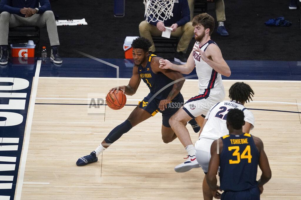 Darron Cummings West Virginia's Gabe Osabuohien (3) goes to the basket against Gonzaga's Drew Timme during the first half of an NCAA college basketball game Wednesday, Dec. 2, 2020, in Indianapolis. (AP Photo/Darron Cummings)