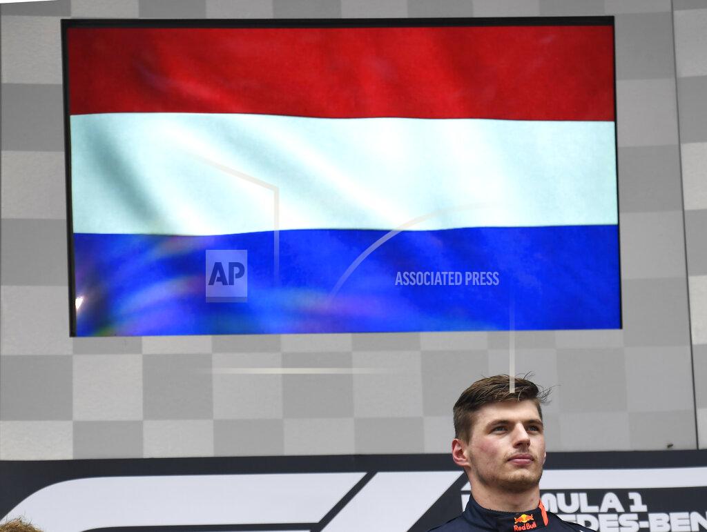 Jens Meyer Red Bull driver Max Verstappen of the Netherland's stands on the podium during the Dutch national anthem after he won the German Formula One Grand Prix at the Hockenheimring racetrack in Hockenheim, Germany, Sunday, July 28, 2019. (AP Photo/Jens Meyer)