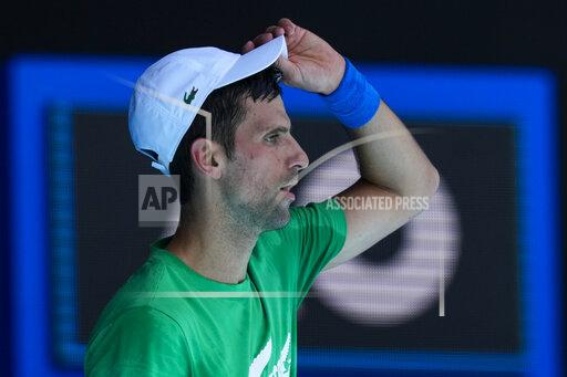 FILE - Defending men's champion Serbia's Novak Djokovic practices on Margaret Court Arena ahead of the Australian Open tennis championship in Melbourne, Australia, Jan. 13, 2022. Djokovic’s effort to play in the Australian Open despite being unvaccinated for COVID-19 moved to a higher court as the No. 1-ranked tennis player appealed the second cancellation of his visa. A judge scheduled another hearing for Sunday, Jan. 16. (AP Photo/Mark Baker, File)