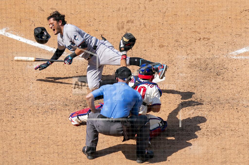 Chris Szagola Miami Marlins' Miguel Rojas, left, reacts to getting hit by a pitch during the seventh inning of a baseball game, Sunday, July 26, 2020, in Philadelphia. (AP Photo/Chris Szagola)