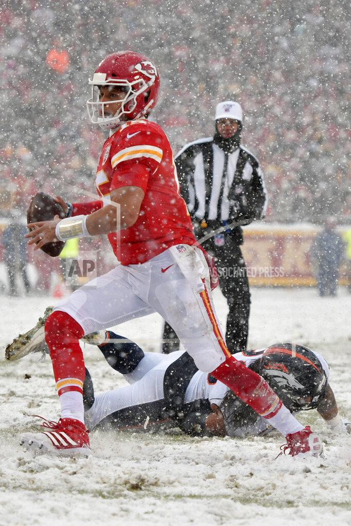 Ed Zurga Kansas City Chiefs quarterback Patrick Mahomes avoids a tackle by Denver Broncos defensive lineman Mike Purcell, rear, during the second half of an NFL football game in Kansas City, Mo., Sunday, Dec. 15, 2019. (AP Photo/Ed Zurga)