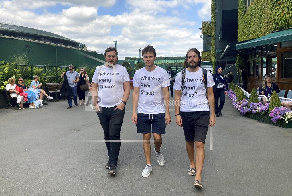 Rebecca Speare-Cole From left Protesters Will Hoyles, 39, Caleb Compton, 27, and Jason Leith, 34, who all work for Free Tibet pose for the media in T-shirts reading "Where is Peng Shuai", at the Wimbledon Tennis tournament in London, Monday, July 4, 2022. Four activists wearing “Where is Peng Shuai?” T-shirts were stopped by security at Wimbledon on Monday and had their bags searched. (Rebecca Speare-Cole/PA via AP)