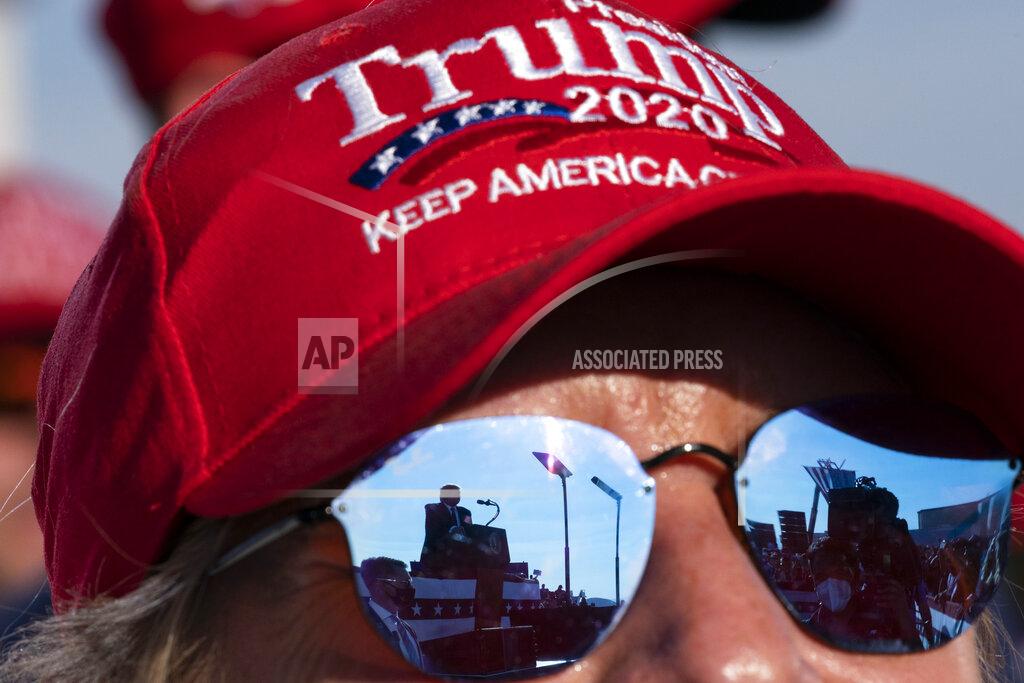 Alex Brandon Reflected in a supporter's sunglasses, President Donald Trump speaks at a campaign rally at Tucson International Airport, Monday, Oct. 19, 2020, in Tucson, Ariz. (AP Photo/Alex Brandon)