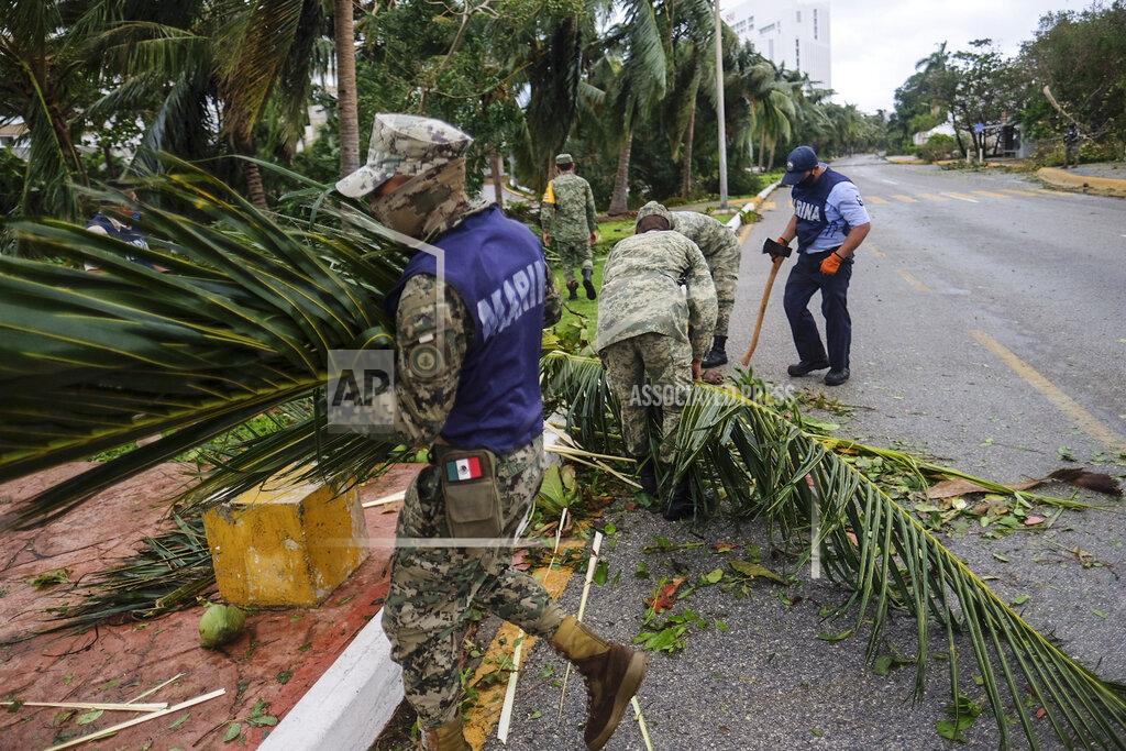 Victor Ruiz Garcia Soldiers clear blocked roads after Hurricane Delta in Cancun, Mexico, Wednesday, Oct. 7, 2020. Hurricane Delta made landfall Wednesday just south of the Mexican resort of Cancun as a Category 2 storm, downing trees and knocking out power to some resorts along the northeastern coast of the Yucatan Peninsula. (AP Photo/Victor Ruiz Garcia)