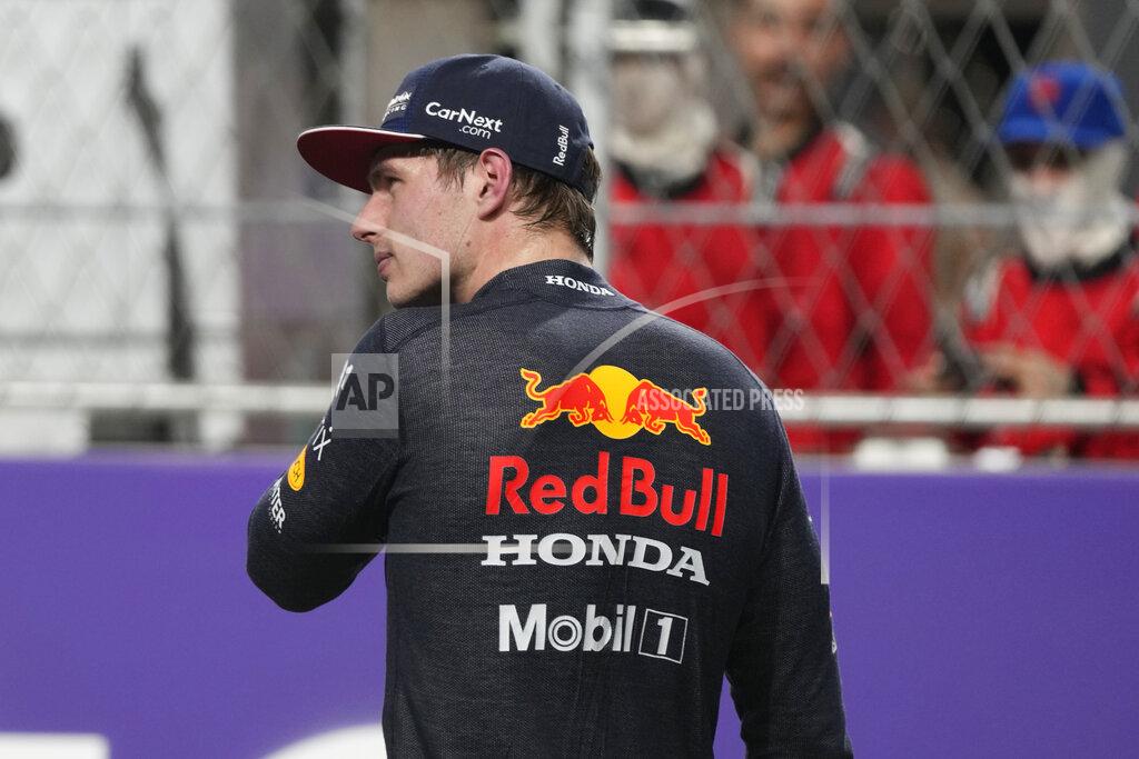Hassan Ammar Red Bull driver Max Verstappen of the Netherlands walks back to the pit lane during qualifying for the Saudi Arabian Grand Prix in Jiddah, Saturday, Dec. 4, 2021. (AP Photo/Hassan Ammar)