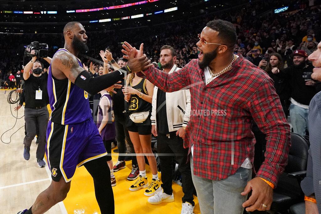 Mark J. Terrill Los Angeles Lakers forward LeBron James, left, greets Aaron Donald of the Los Angeles Rams after the Lakers defeated the Utah Jazz 106-101in an NBA basketball game Wednesday, Feb. 16, 2022, in Los Angeles. The Lakers won 106-101. (AP Photo/Mark J. Terrill)