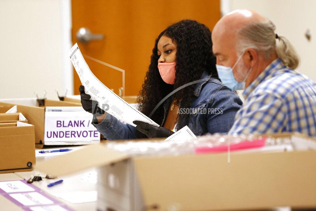 Joshua L. Jones Athens-Clarke County poll workers hand recount ballots at Board of Elections in Athens, Ga.,on Friday, Nov. 13, 2020. Election officials in Georgia’s 159 counties are undertaking a hand tally of the presidential race that stems from an audit required by state law. (Joshua L. Jones/Athens Banner-Herald via AP)