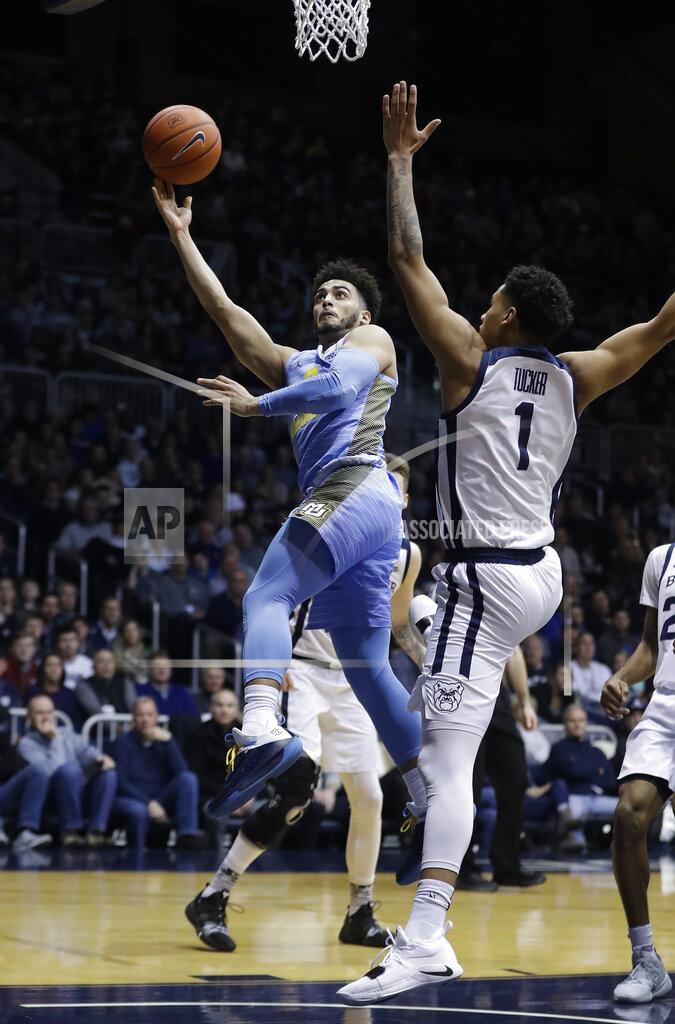 Darron Cummings Marquette's Markus Howard (0) puts up a shot against Butler's Jordan Tucker (1) during the second half of an NCAA college basketball game, Wednesday, Jan. 30, 2019, in Indianapolis. Marquette won 76-58. (AP Photo/Darron Cummings)