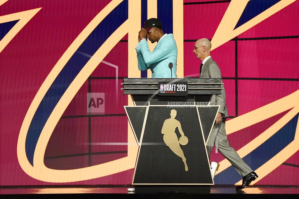 Corey Sipkin Evan Mobley walks off the stage with NBA Commissioner Adam Silver after being selected third overall by the Cleveland Cavaliers during the NBA basketball draft, Thursday, July 29, 2021, in New York. (AP Photo/Corey Sipkin)
