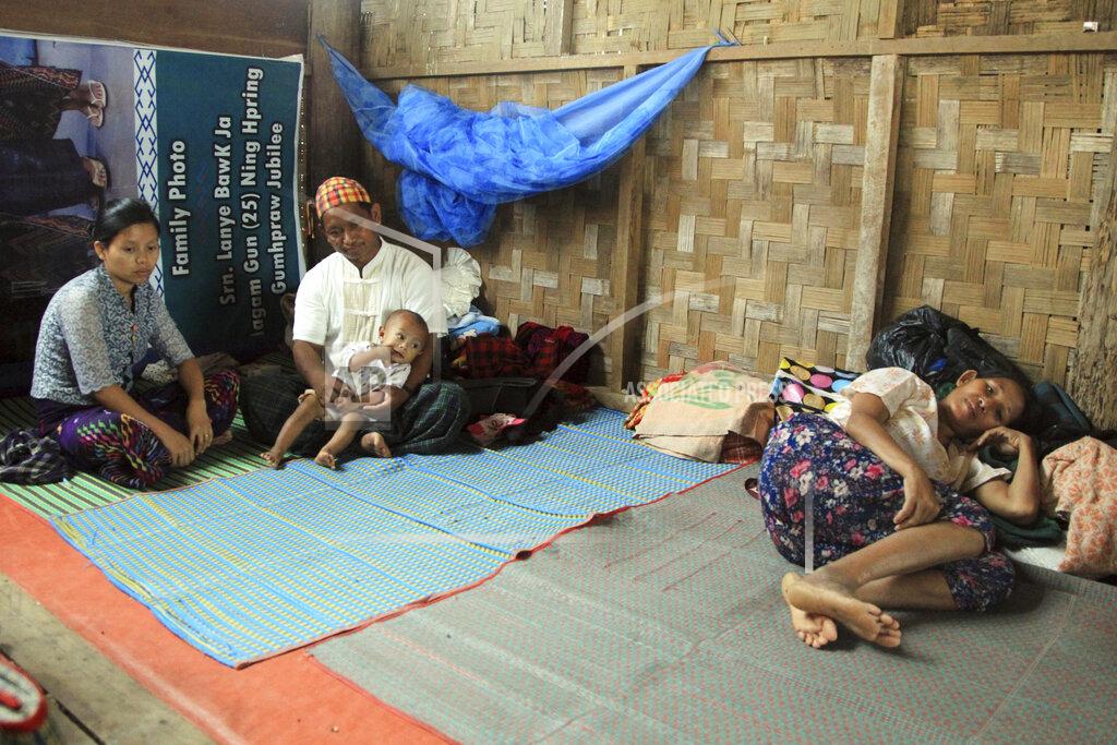 Uncredited FILE - In this May 6, 2018, file photo, internally displaced ethnic Kachins rest at their hut in compound of Trinity Baptist Church refugee camp in Myitkyina, Kachin State, northern Myanmar. Far away in Myanmar’s borderlands, millions of others who hail from Myanmar’s minority ethnic groups are facing increasing uncertainty and waning security as longstanding conflicts between the military and minority guerrilla armies flare anew. (AP Photo)