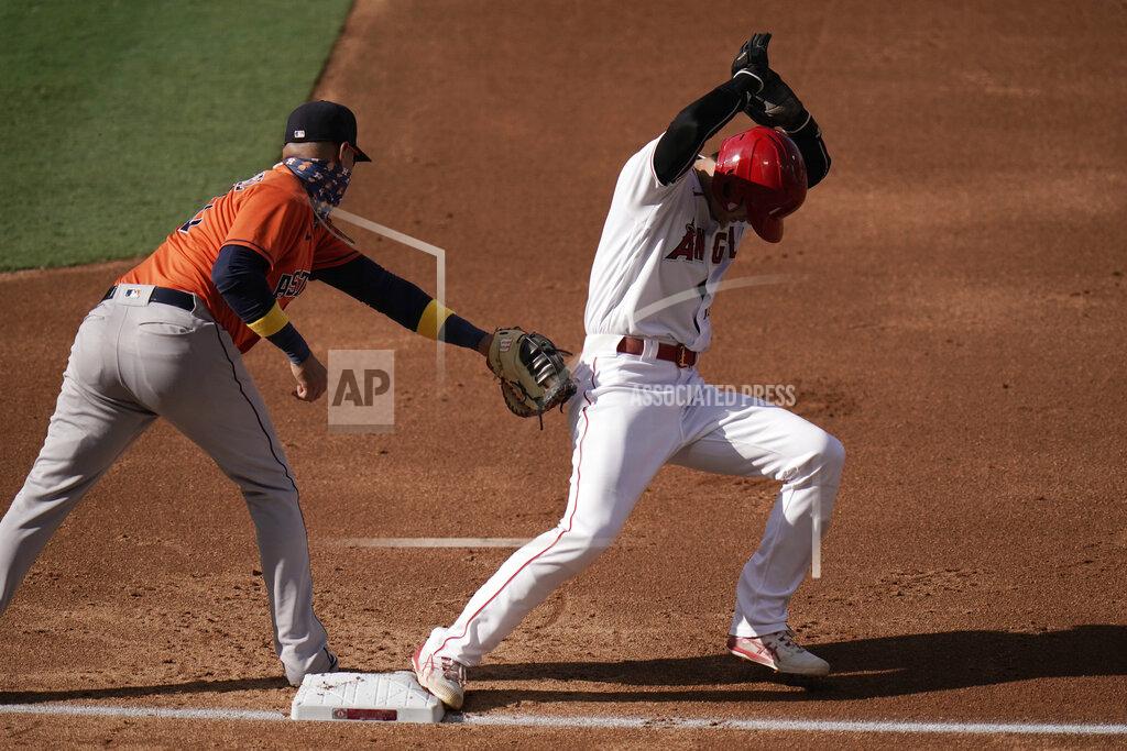 Jae C. Hong Los Angeles Angels' Shohei Ohtani, right, of Japan, avoids a tag from Houston Astros first baseman Yuli Gurriel during the first inning of the first baseball game of a doubleheader, Saturday, Sept. 5, 2020, in Anaheim, Calif. (AP Photo/Jae C. Hong)