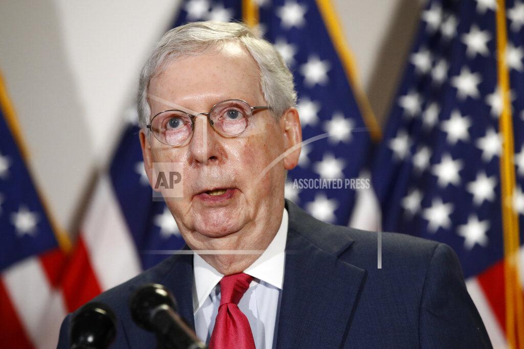 In this May 19, 2020, photo, Senate Majority Leader Mitch McConnell of Ky., speaks with reporters after meeting with Senate Republicans at their weekly luncheon on Capitol Hill in Washington. Congress is at a crossroads in the Covid-19 crisis. Lawmakers are wrestling over whether to “go big” as House Speaker Nancy Pelosi wants for the next relief bill or hit “pause” as McConnell insists. (AP Photo/Patrick Semansky)
