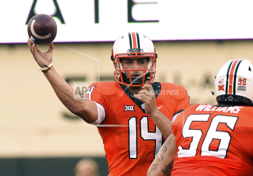 Brody Schmidt FILE - In this Aug. 30, 2018, file photo, Oklahoma state quarterback Taylor Cornelius (14) throws a pass during the first quarter of an NCAA college football game against Missouri State, in Stillwater, Okla. Oklahoma State coach Mike Gundy considers Taylor Cornelius somewhat of a dinosaur, and not because his starting quarterback’s 23rd birthday is coming up. (AP Photo/Brody Schmidt, File)