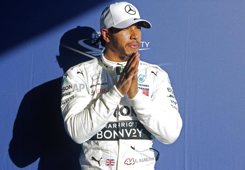 Rick Rycroft Mercedes driver Lewis Hamilton of Britain puts his hands together after qualifying on pole for the Australian Grand Prix in Melbourne, Australia, Saturday, March 16, 2019. The first race of the year is Sunday. (AP Photo/Rick Rycroft)