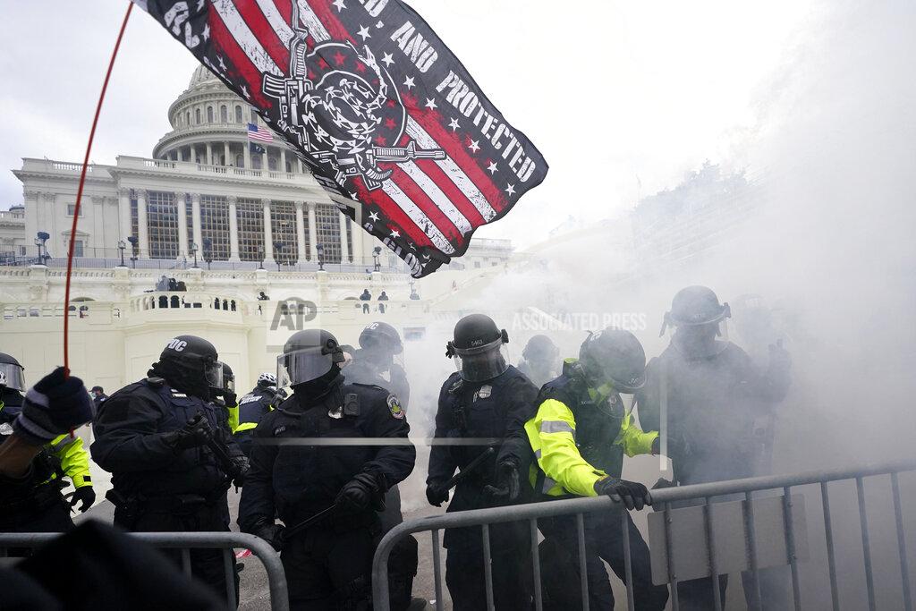 Julio Cortez Police hold off Trump supporters who tried to break through a police barrier, Wednesday, Jan. 6, 2021, at the Capitol in Washington. As Congress prepares to affirm President-elect Joe Biden's victory, thousands of people have gathered to show their support for President Donald Trump and his claims of election fraud. (AP Photo/Julio Cortez)