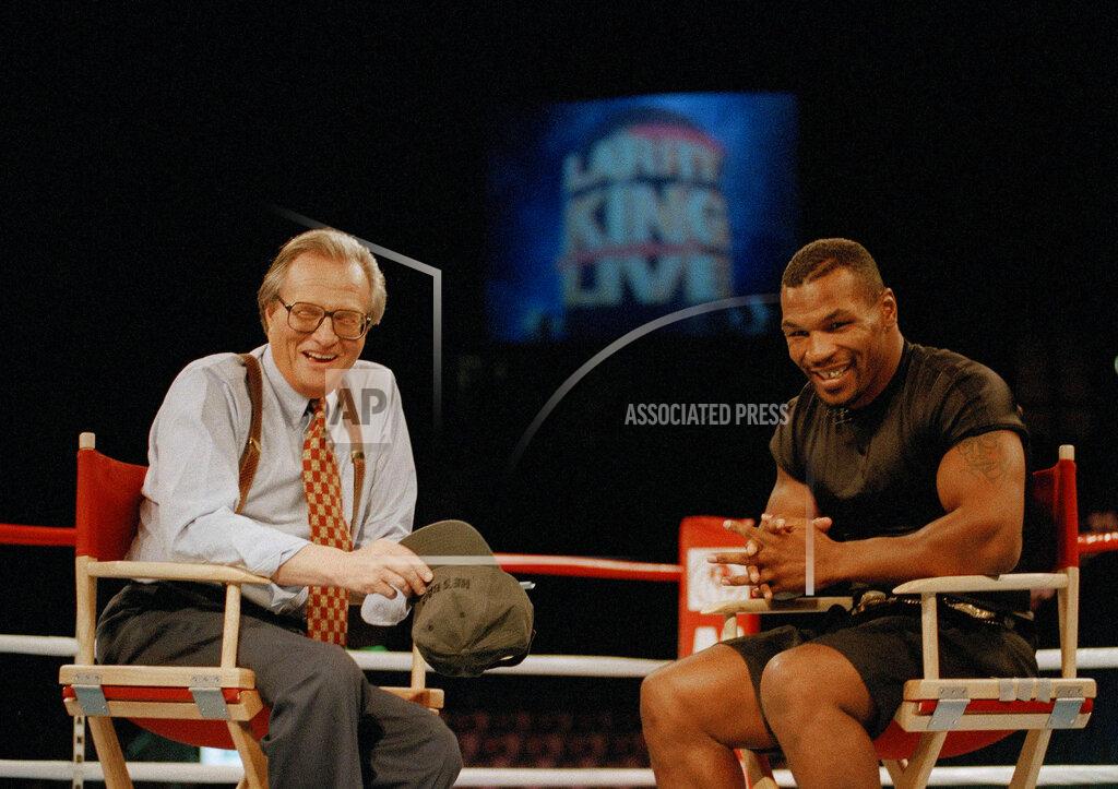 Lennox Mclendon FILE - In this Aug. 16, 1995 file photo, former heavyweight champion Mike Tyson, right, shares a laugh with TV talk show host Larry King during the broadcasting of the "Larry King Live" show from inside the ring at the MGM Grand Gardens in Las Vegas. King, who interviewed presidents, movie stars and ordinary Joes during a half-century in broadcasting, has died at age 87. Ora Media, the studio and network he co-founded, tweeted that King died Saturday, Jan. 23, 2021 morning at Cedars-Sinai Medical Center in Los Angeles. (AP Photo/Lennox McLendon, File)