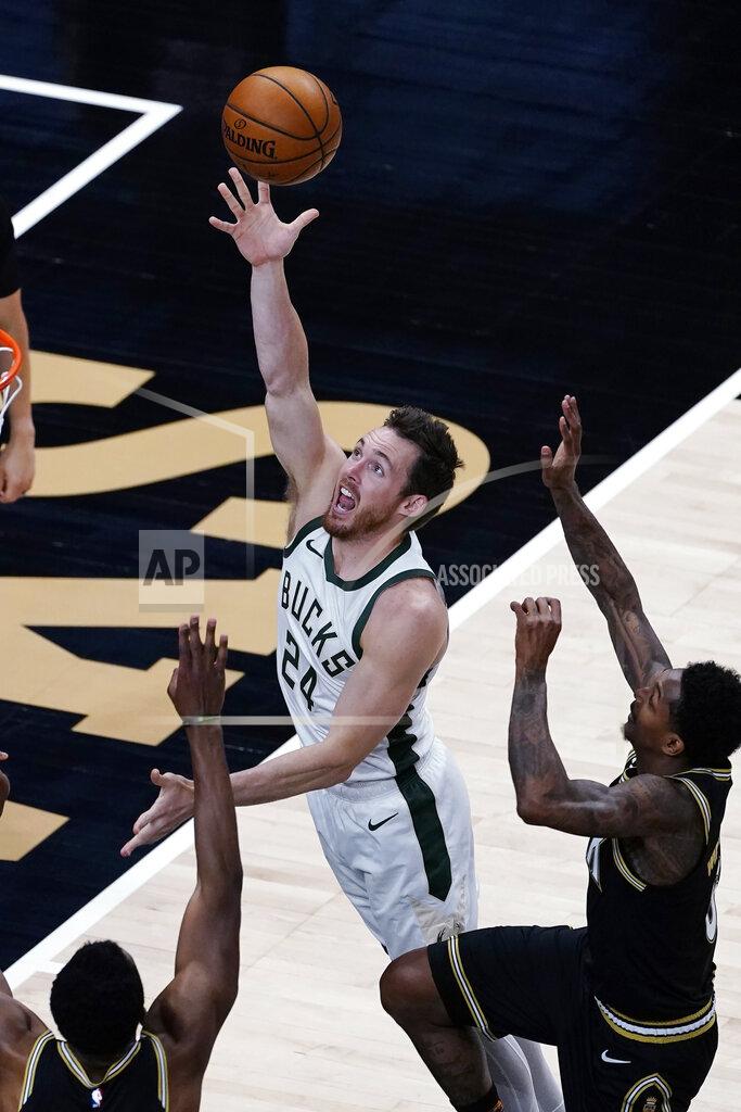 John Bazemore Milwaukee Bucks guard Pat Connaughton (24) goes in for a basket as Atlanta Hawks guard Lou Williams, right, defends during the first half of an NBA basketball game Thursday, April 15, 2021, in Atlanta. (AP Photo/John Bazemore)