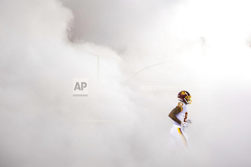 Patrick Semansky Washington Football Team tight end Ricky Seals-Jones (83) runs through a cloud of smoke as he takes the field during team introductions before the start of first half of an NFL football game against the New York Giants, Sept. 16, 2021, in Landover, Md. (AP Photo/Patrick Semansky)