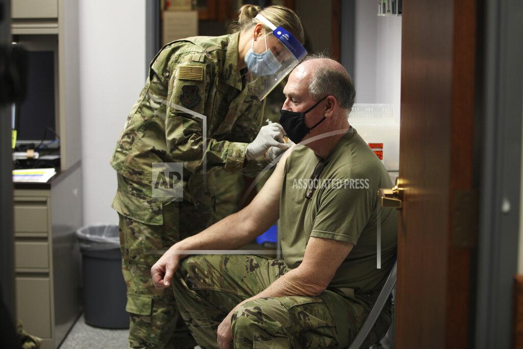 John Hanna Kansas Air National Guard Maj. Cortney Neblett, left, gives a COVID-19 vaccine shot to Master Sgt. Thomas Lafountain, right, during a clinic for Kansas National Guard personnel, Friday, Feb. 5, 2021, at Air National Guard's base south of Topeka, Kan. The Kansas National Guard received 1,100 doses from the U.S. Department of Defense.(AP Photo/John Hanna)