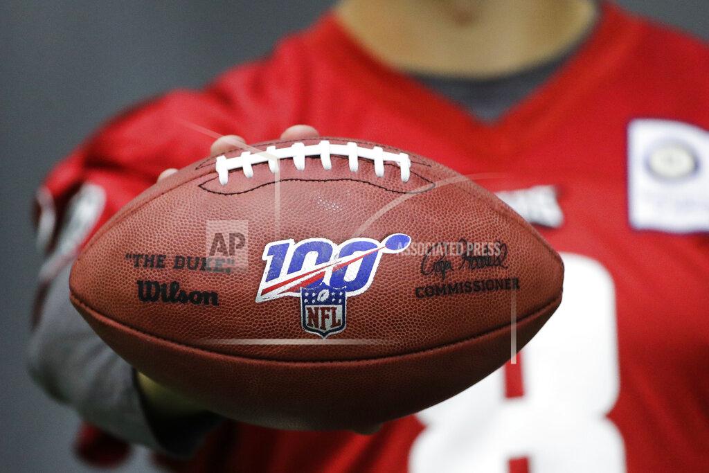 Matt Rourke In this Oct. 17, 2019, photo, Philadelphia Eagles practice squad quarterback Kyle Lauletta displays a football during an interview with The Associated Press at the NFL football team's training facility in Philadelphia. Those shiny “NFL 100” logos on all the footballs being used to commemorate the league’s centennial season are part of a lengthy process that goes into making each handcrafted leather game ball. Wilson has been the official game ball of the NFL since 1941. The size, shape and feel of the football have evolved over the years, but the personal touch remains the same.(AP Photo/Matt Rourke)