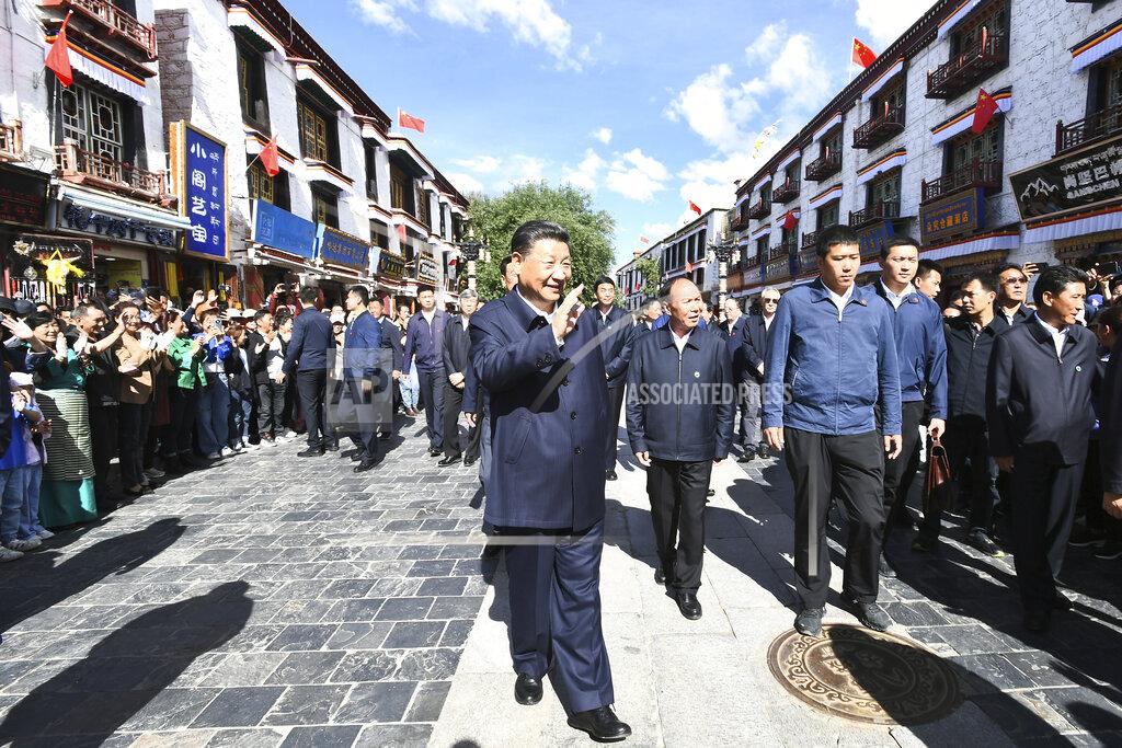 Xie Huanchi In this July 22, 2021 photo released by China's Xinhua News Agency, Chinese President Xi Jinping, center, visits Barkhor Street near the Jokhang Temple in Lhasa in western China's Tibet Autonomous Region. Chinese leader Xi Jinping has made a rare visit to Tibet as authorities tighten controls over the Himalayan region's traditional Buddhist culture, accompanied by an accelerated drive for economic development. (Xie Huanchi/Xinhua via AP)