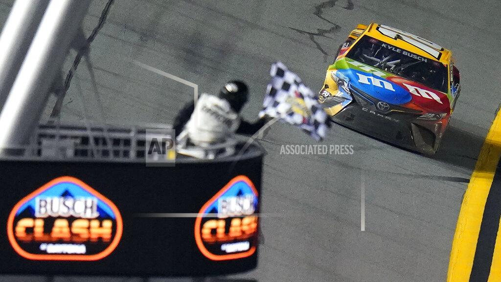 Chris O'meara Kyle Busch (18) takes the checkered flag to win the NASCAR Daytona Clash auto race Tuesday, Feb. 9, 2021, at Daytona International Speedway in Daytona Beach, Fla. (AP Photo/Chris O'Meara)
