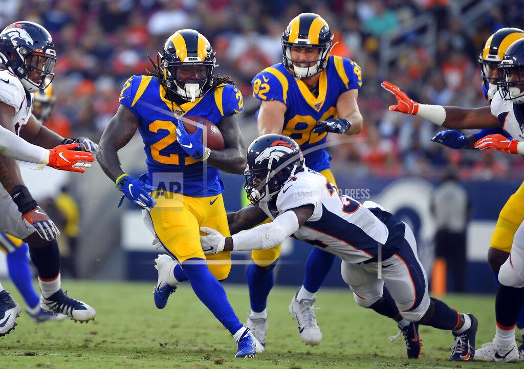 Mark J. Terrill Los Angeles Rams running back Darrell Henderson, left, runs against the Denver Broncos during the first half of an NFL preseason football game Saturday, Aug. 24, 2019, in Los Angeles. (AP Photo/Mark J. Terrill)