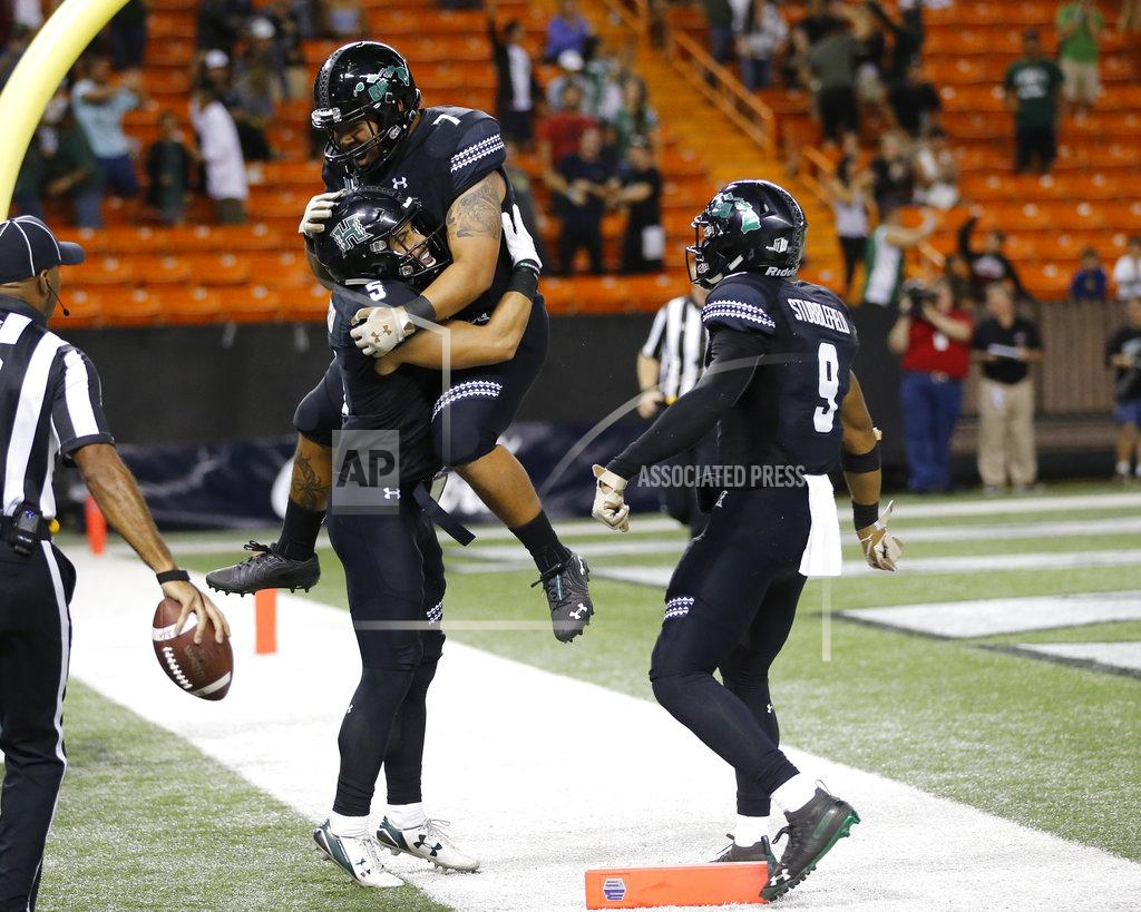 Marco Garcia Hawaii wide receiver Cedric Byrd (6) celebrates with teammates running back Dayton Furuta (7) and wide receiver Devan Stubblefield (9) after he made the game winning touchdown against UNLV during the fourth quarter of an NCAA college football game, Saturday, Nov. 17, 2018, in Honolulu. Hawaii defeated UNLV 35-28. (AP Photo/Marco Garcia)
