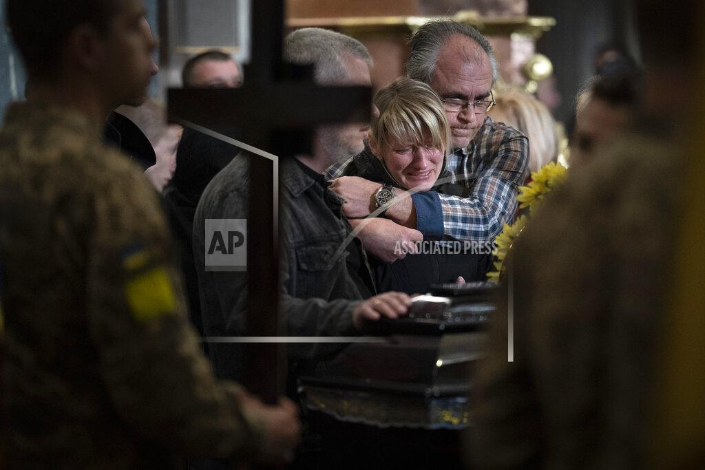 Emilio Morenatti Natalia Pohoreltseva, mourns at the coffin of her son Melnyk Andriy, 23, a Ukrainian military servicemen who was killed in Kharkiv province, during his funeral in Lviv, Ukraine, Saturday, May 14, 2022. (AP Photo/Emilio Morenatti)