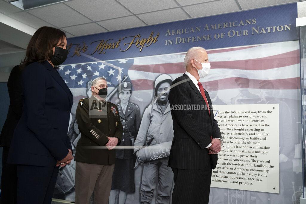 President Joe Biden, accompanied by Vice President Kamala Harris, left, and Joint Chiefs Chairman Gen. Mark Milley, tours the African Americans in Defense of our Nations Corridor at the Pentagon, Wednesday, Feb. 10, 2021, in Washington. (AP Photo/Alex Brandon, Pool)