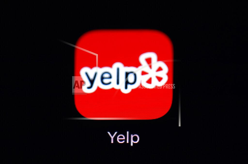 Patrick Semansky FILE - The Yelp app is seen on an iPad, March 19, 2018. After the U.S. Supreme Court revoked the federal right to an abortion that's been in place for half a century, companies like Amazon, Disney, Apple and JP Morgan pledged to cover travel costs for employees who live in states where the procedure is now illegal so they can terminate pregnancies. Yelp said its abortion travel benefit is administered by its health insurance provider. Yelp has told its employees that if they do use the travel benefit, Yelp will not have access to the details of the service. (AP Photo/Patrick Semansky, File)