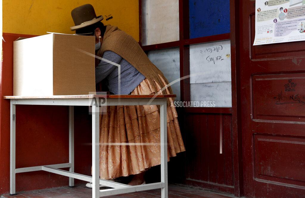Juan Karita A woman stands at the voting booth during general elections in La Paz, Bolivia, Sunday, Oct. 18, 2020. (AP Photo/Juan Karita)