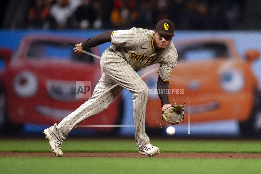 D. Ross Cameron San Diego Padres third baseman Manny Machado fields a grounder by San Francisco Giants' Buster Posey during the fourth inning of a baseball game Tuesday, Sept. 14, 2021, in San Francisco. Posey was out at first. (AP Photo/D. Ross Cameron)