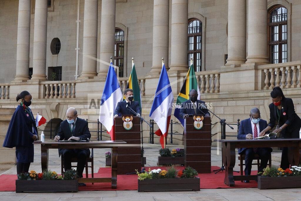 Themba Hadebe South African President Cyril Ramaphosa, right, and his French counterpart Emmanuel Macron speak during a press conference at the government's Union Building, in Pretoria, South Africa, Friday, May 28, 2021. Macron is on a two-day official visit to the country. (AP Photo/Themba Hadebe, Pool)