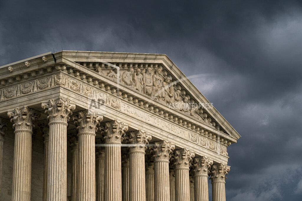 J. Scott Applewhite FILE - In this June 20, 2019, file photo, the Supreme Court in Washington. The educational records of a star University of Montana quarterback accused of rape will remain confidential after the Supreme Court declined to get involved in the case brought by author Jon Krakauer. (AP Photo/J. Scott Applewhite, File)