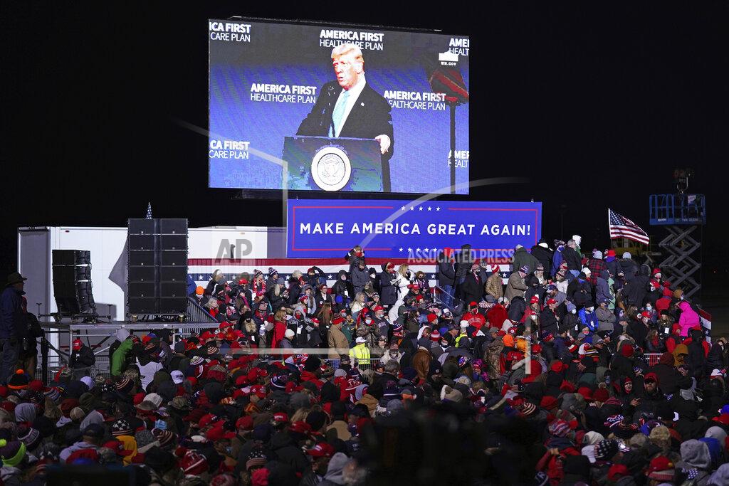 Nati Harnik An image of President Donald Trump is projected on a large screen as supporters wait for his arrival to a campaign rally in Omaha, Neb., Tuesday, Oct. 27, 2020. (AP Photo/Nati Harnik)