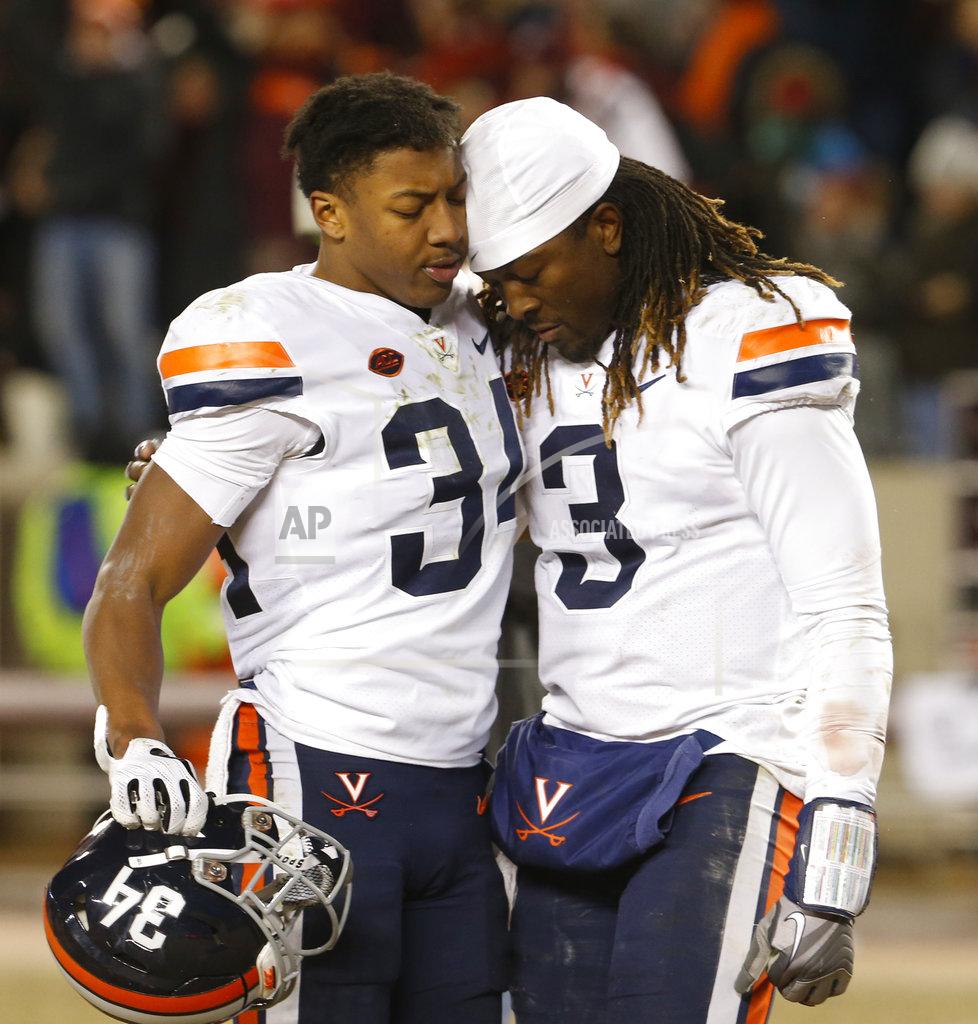 Steve Helber Virginia quarterback Bryce Perkins (3) is consoled by cornerback Bryce Hall (34) after an NCAA college football game against Virginia Tech in Blacksburg, Va., Friday, Nov. 23, 2018. Virginia Tech won 34-31. (AP Photo/Steve Helber)