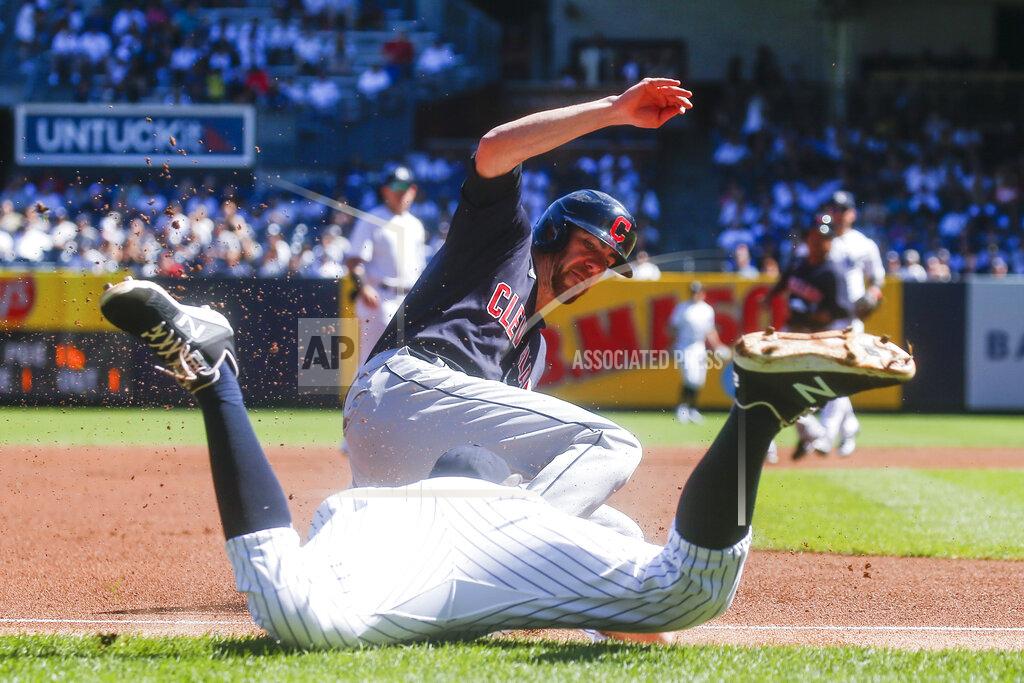 Eduardo Munoz Alvarez Cleveland Indians' Bradley Zimmer, right, dives safely into third base as New York Yankees' DJ LeMahieu tries to tag him out in the first inning of a baseball game, Sunday, Sept. 19, 2021, in New York. (AP Photo/Eduardo Munoz Alvarez)