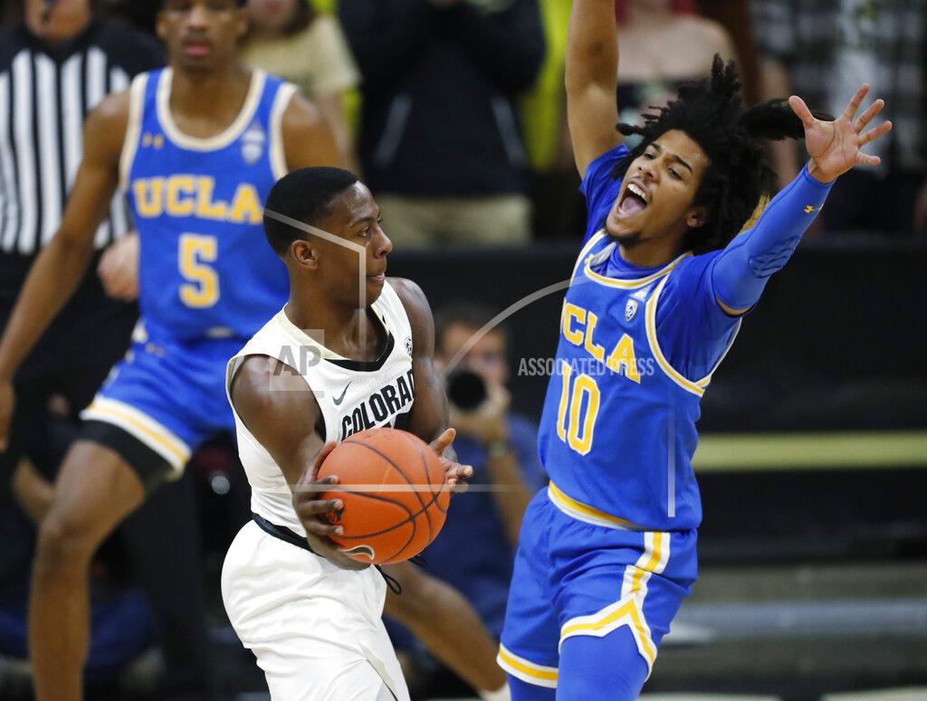 David Zalubowski Colorado guard McKinley Wright IV, left, passes the ball as UCLA guard Tyger Campbell defends in the first half of an NCAA college basketball game Saturday, Feb. 22, 2020, in Boulder, Colo. (AP Photo/David Zalubowski)