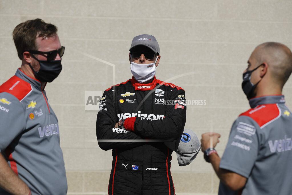 Darron Cummings Race driver driver Will Power, middle, of Australia, talks with his crew after winning the pole for the IndyCar auto race at Indianapolis Motor Speedway in Indianapolis, Friday, July 3, 2020. (AP Photo/Darron Cummings)