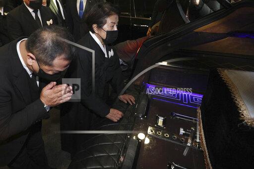 Lee Soon-ja, second from right, the wife of the late former South Korean President Chun Doo-hwan, watches the coffin containing the body of her husband at a funeral hall in Seoul, South Korea, Saturday, Nov. 27, 2021. Former South Korean military strongman Chun, who crushed pro-democracy demonstrations in 1980, died on Tuesday. He was 90. (Korea Pool via AP)