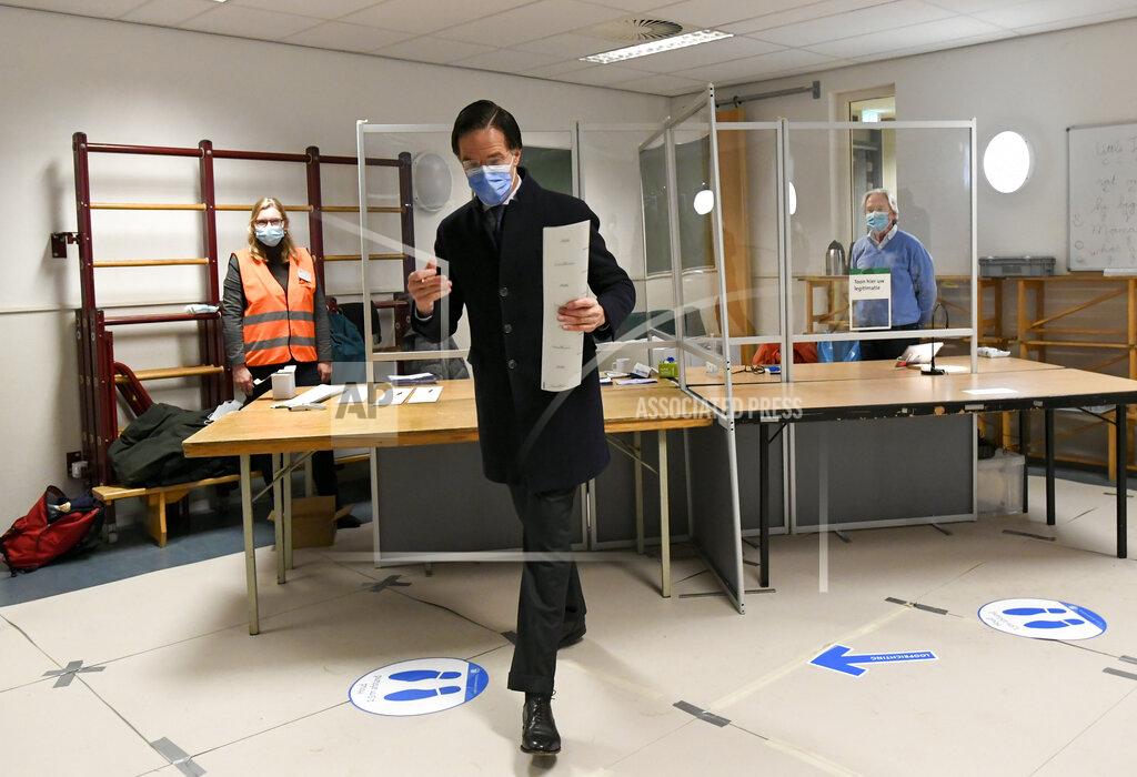 Piroschka Van De Wouw Dutch caretaker Prime Minister Mark Rutte of the VVD Liberal party holds a ballot as he votes in the Dutch general election in The Hague, Netherlands, March 17, 2021. (Piroschka Van De Wouw/Pool via AP)