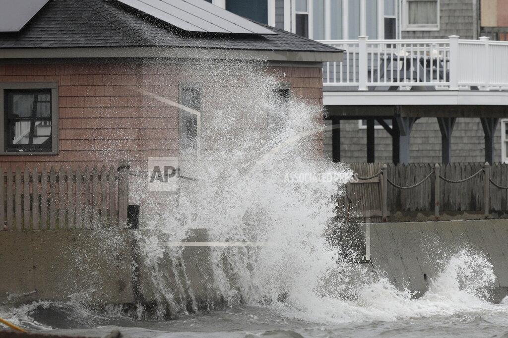 Peter Pereira A wave crashes into the retaining wall of a home in Fairhaven, Mass. on Tuesday, Oct. 26, 2021 as a powerful nor'easter makes its way across the Northeast. (Peter Pereira/The Standard-Times via AP)