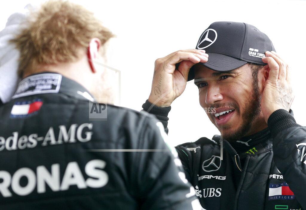 Stephanie Lecocq Race winner Mercedes driver Lewis Hamilton of Britain, right, speaks with second placed Mercedes driver Valtteri Bottas of Finland after the Formula One Grand Prix at the Spa-Francorchamps racetrack in Spa, Belgium, Sunday, Aug. 30, 2020. (Stephanie Lecocq, Pool via AP)