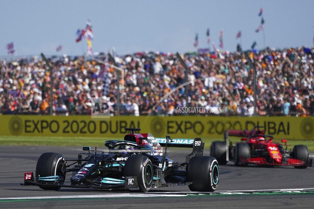 Jon Super Mercedes driver Lewis Hamilton of Britain steers his car ahead of Ferrari driver Charles Leclerc of Monaco, right, during the British Formula One Grand Prix, at the Silverstone circuit, in Silverstone, England, Sunday, July 18, 2021. (AP Photo/Jon Super)